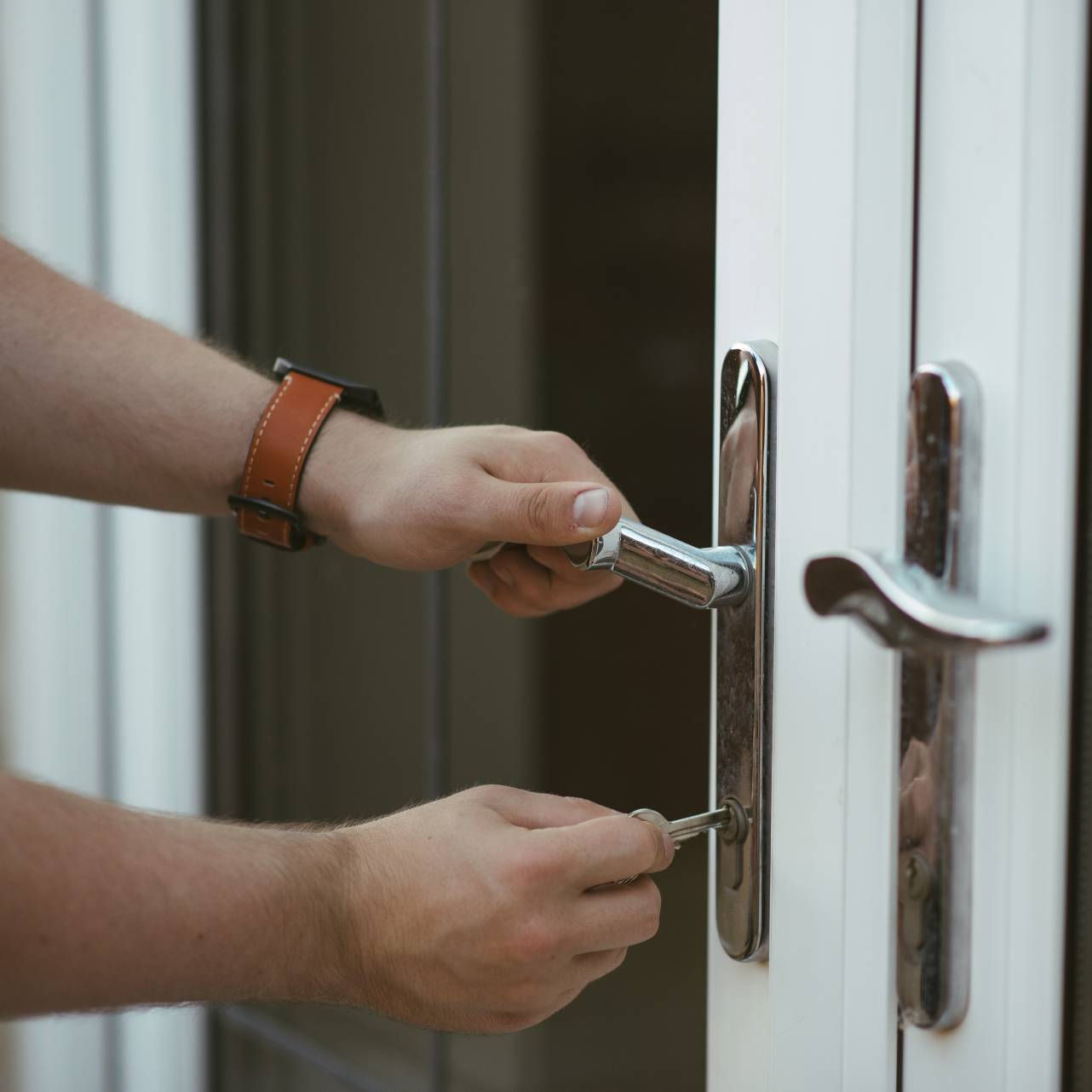 hands locking a door and other Front Doors in Clearwater, Largo, FL, Palm Harbor, FL, St. Petersburg, Tarpon Springs